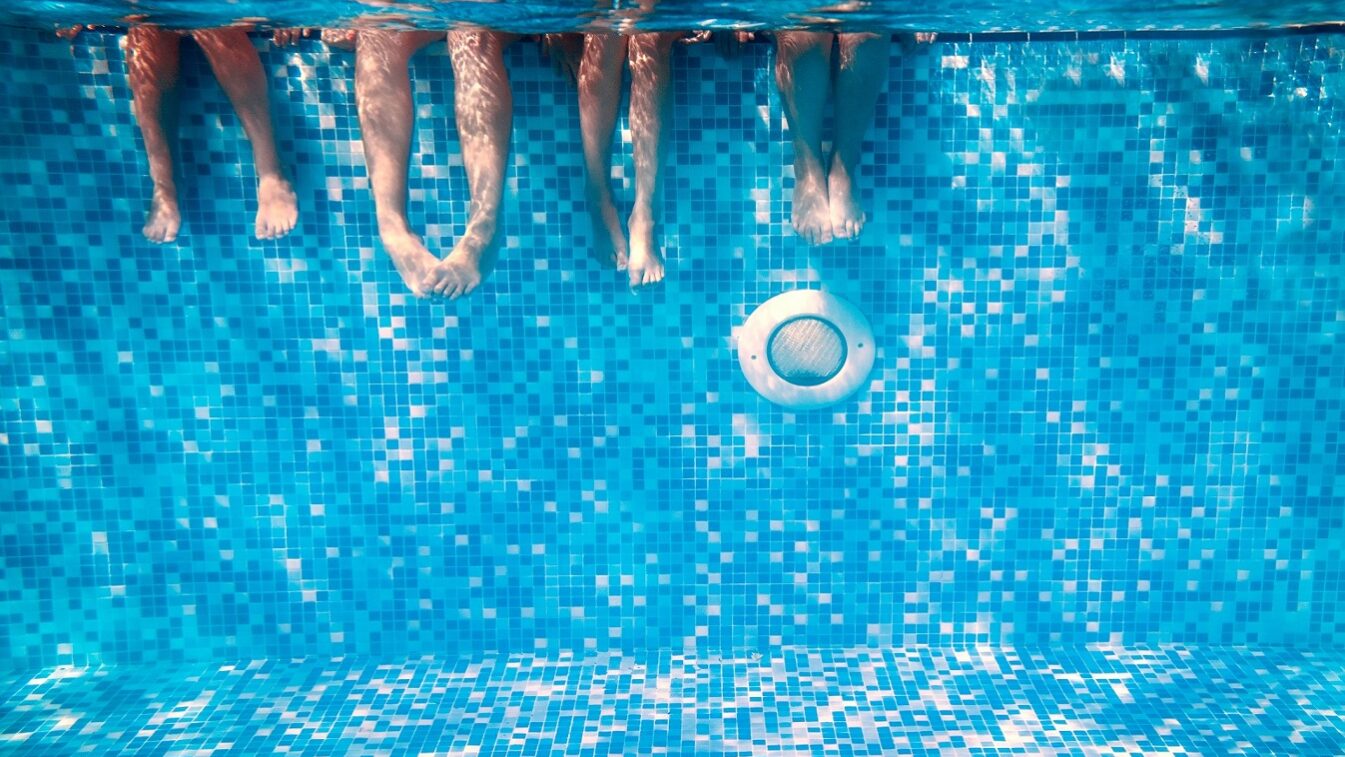 Children’s,And,Adults,Legs,Underwater,In,The,Swimming,Pool