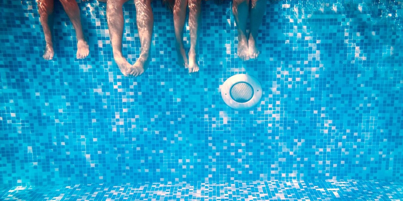 Children’s,And,Adults,Legs,Underwater,In,The,Swimming,Pool